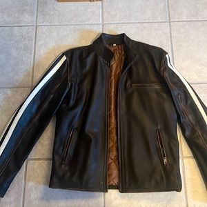 Brown leather jacket with white stripes on sleeves.